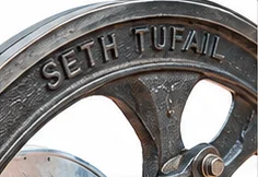Seth Tufail name on the flywheel of a toka machine